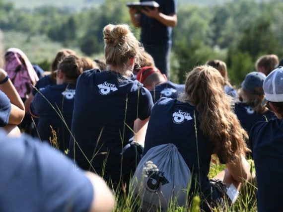 Youth listening to message on a youth mission trip